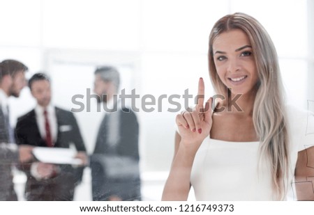 Business woman pushing on a glass Board.