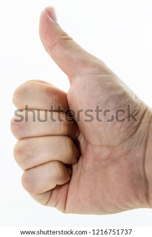 A thumbs up gesture performed by real human(Caucasian) hand. Customer satisfaction concept image. 