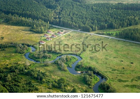 Aerial view over agricultural fields and small river
