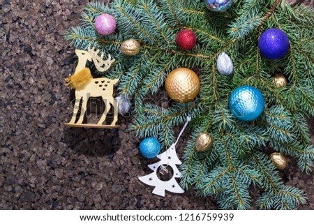 Christmas fir tree with decoration and glitters on wooden background