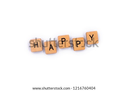 HAPPY, spelt with wooden letter tiles over a plain white background. 