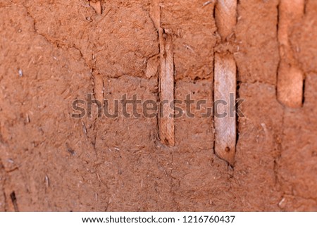 Red loam wall as a background. Closed up image. Rustic style.
