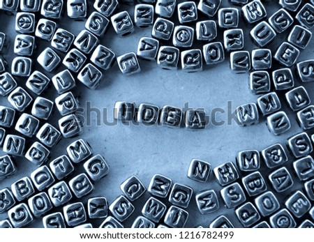 Idea - Word from Metal Blocks on Paper - Concept Photo on Table
