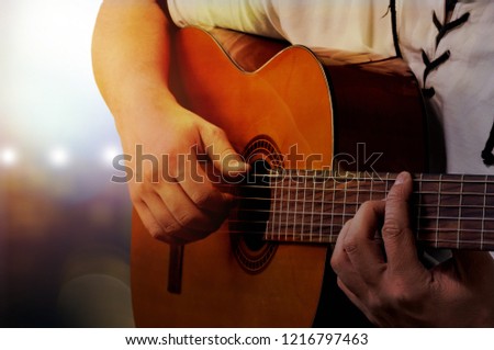 A man playing acoustic guitar in recording