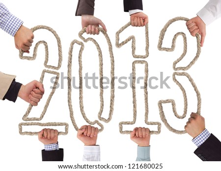 Hands holding bricks forming year 2013
