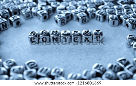 Context - Word from Metal Blocks on Paper - Concept Photo on Table
