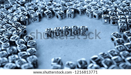 Nudge - Word from Metal Blocks on Paper - Concept Photo on Table
 Royalty-Free Stock Photo #1216813771