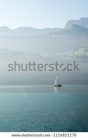Romantic picture of boat sailing on a foggy lake Lucerne in Switzerland