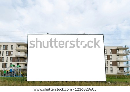 Blank white billboard for advertisement in the front of modern residential building.
