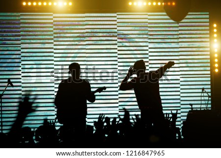 Silhouettes of music band on the stage. Concert scene. Rock band silhouette.