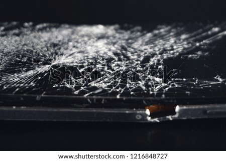 Broken phone on black background, phone repair advertisement, broken screen in smartphone