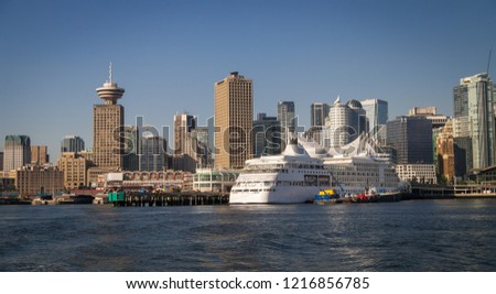 Vancouver BC, - downtown Vancouver skyline viewed from the Burrard Inlet on a sunny day with cloudless blue sky