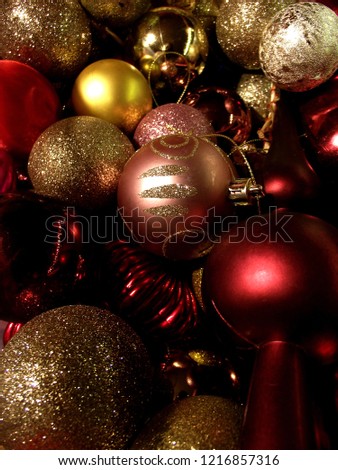 Christmas tree ornaments. Red, gold and pink balls with lot of shining and glitter.