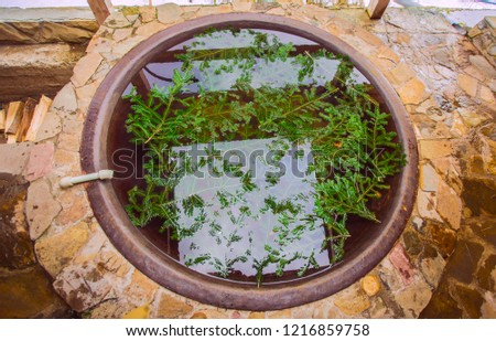 Open air bath outdoors in winter. Iron tub for bathing in hot water.