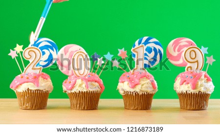 2019 Happy New Year's candyland lollipop drip cupcakes on green chroma key background.