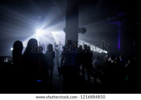 party concert,night party concert,people dancing in outdoor concert party,blur and Flair image,selective focus. Audience enjoying a concert on a music festival / great concert outdoors. blurred image