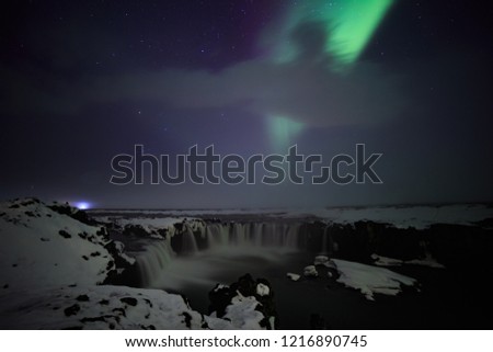 Northern Lights at Godafoss waterfall in winter, Iceland.