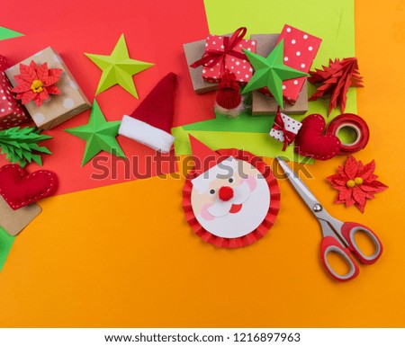 The decor for the Christmas decor lies on an orange background. Gift wrapping materials. Advent calendar.