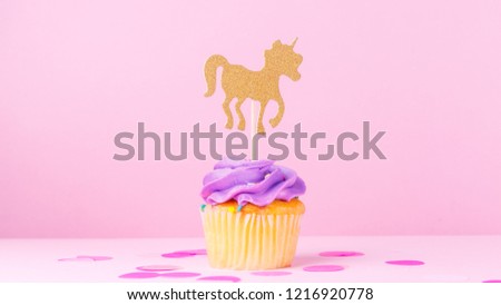 Creative pastel fantasy holiday card with cupcake, confetti and unicorn. Baby shower, birthday, celebration concept. Horizontal, banner, wide screen format