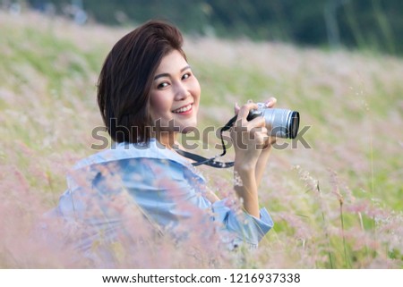 Outdoor summer lifestyle portrait of pretty young asian woman having fun