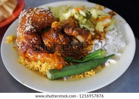 Close up or top view of famous Nasi Kandar in Penang, Malaysia. Rice with variaty dish on a plate. Royalty-Free Stock Photo #1216957876