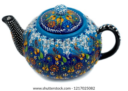 bright ceramic teapot with patterns on white background