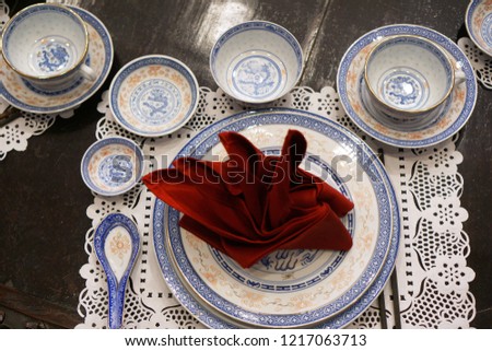 Selective focus of Pinang Peranakan dining room plate setup. Royalty-Free Stock Photo #1217063713