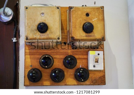 Vintage light switch on the wall. Royalty-Free Stock Photo #1217081299