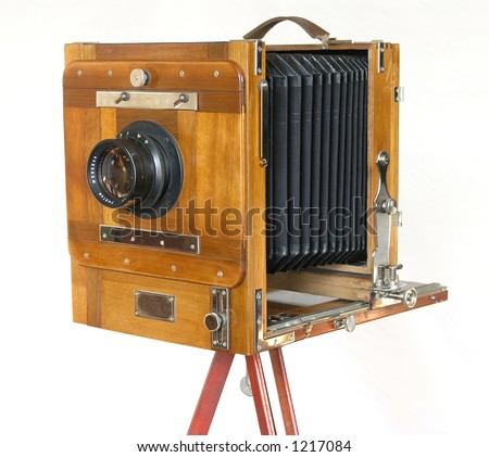 vintage wooden box camera on a tripod on a white background