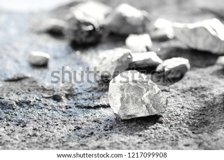 lump of silver or platinum on a stone floor Royalty-Free Stock Photo #1217099908