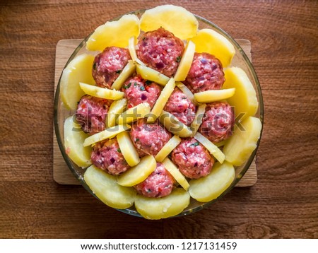 Baked potato gratin with minced meat uncooked. Homemade potato gratin. Royalty-Free Stock Photo #1217131459