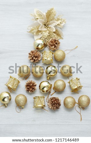 GOLD Christmas, Composition for Christmas and New Year, gift boxes, ball,  two snowy fir tree, on wooden background.