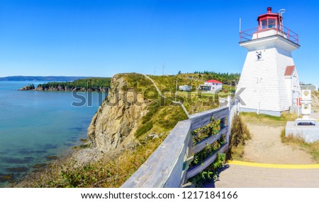 View of the Cape Enrage lighthouse, shoreline and cliffs, in New Brunswick, Canada Royalty-Free Stock Photo #1217184166