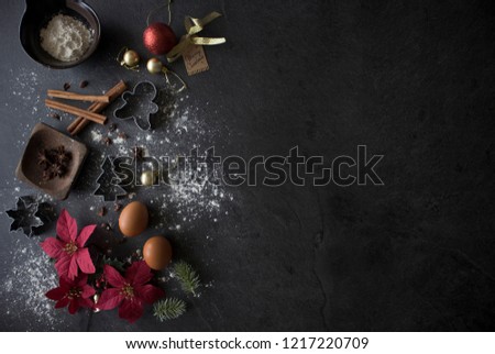 Christmas Baking Ingredients on Black Table, Christmas Flatlay on Dark Background with Copy Space. Christmas Cake Ingredients Top Down Shot