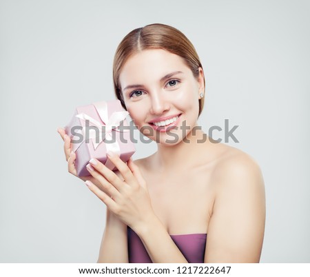 Pretty woman with gift on white background