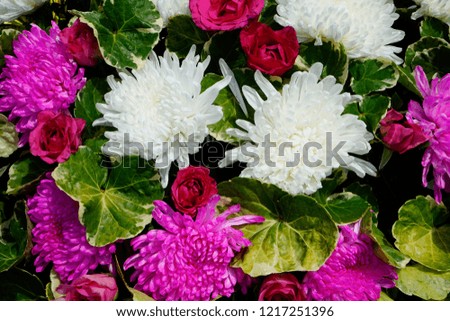 Pattern of natural flowers background texture. beautiful bouquet of mixed flowers in a vase. the work of the florist at a flower shop. background on full screen