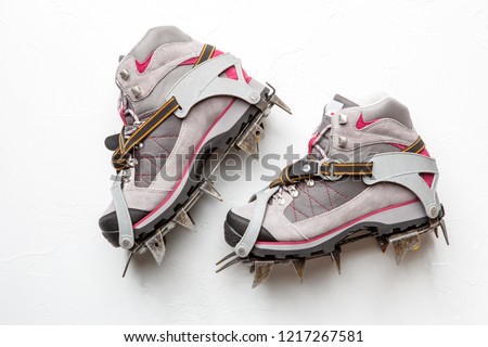 Photo of mountain shoes with spikes isolated on white background