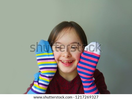 Beautiful girl smiling with socks Royalty-Free Stock Photo #1217269327