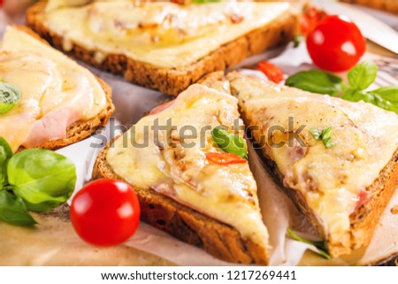 Hawaii toast with ham, cheese and pineapple on a cutting board