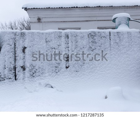 Snow on the fence in winter as a background