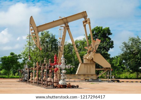 Wellhead and Donky pump in Oil and Gas production with blue sky