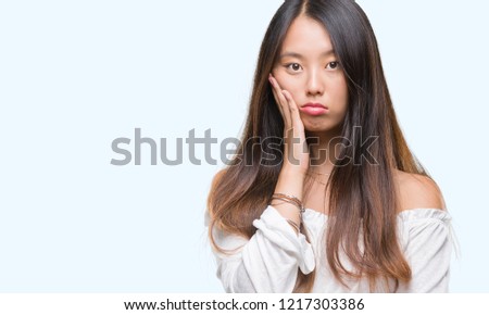 Young asian woman over isolated background thinking looking tired and bored with depression problems with crossed arms.