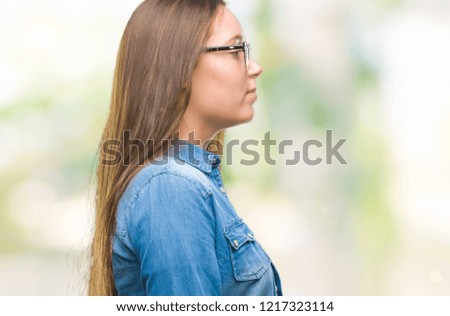 Young beautiful caucasian woman wearing glasses over isolated background looking to side, relax profile pose with natural face with confident smile.