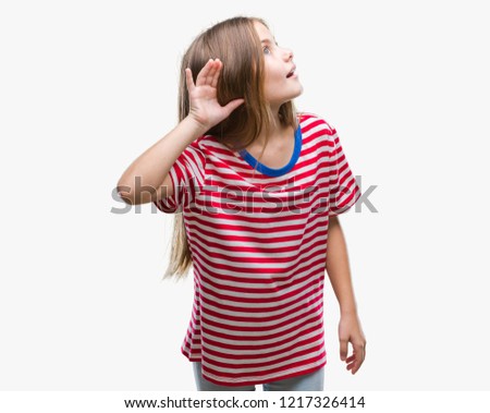 Young beautiful girl over isolated background smiling with hand over ear listening an hearing to rumor or gossip. Deafness concept.