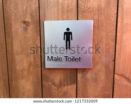 toilet sign for male / female / unisex ambulant with wooden background