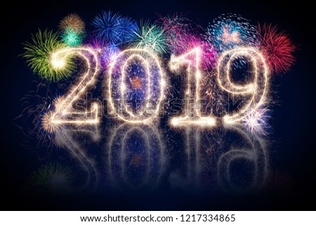 colorful fireworks display and bright sparkler pyrotechnic number 2019 happy new year sylvester concept on black blue background