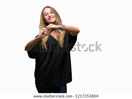 Young beautiful blonde woman over isolated background smiling in love showing heart symbol and shape with hands. Romantic concept.