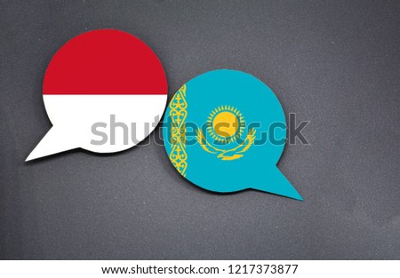 Indonesia and Kazakhstan flags with two speech bubbles on dark gray background