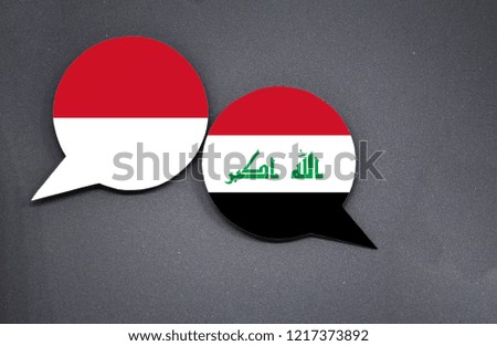 Indonesia and Iraq flags with two speech bubbles on dark gray background