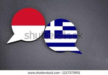 Indonesia and Greece flags with two speech bubbles on dark gray background